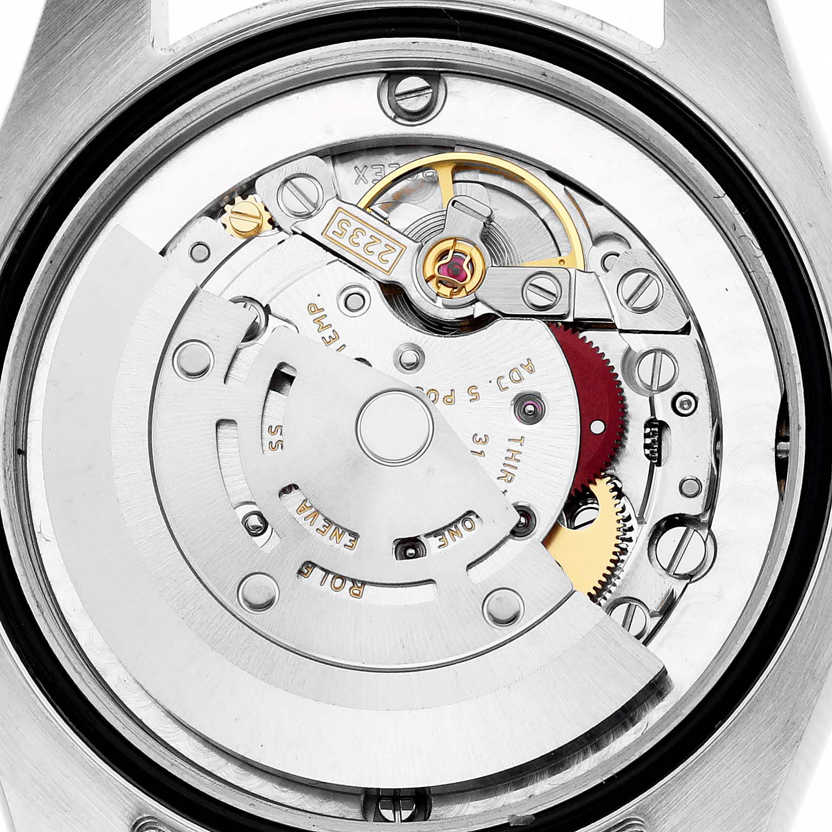 This image shows the movement and internal components of a Mid-Size Rolex watch from a back view.