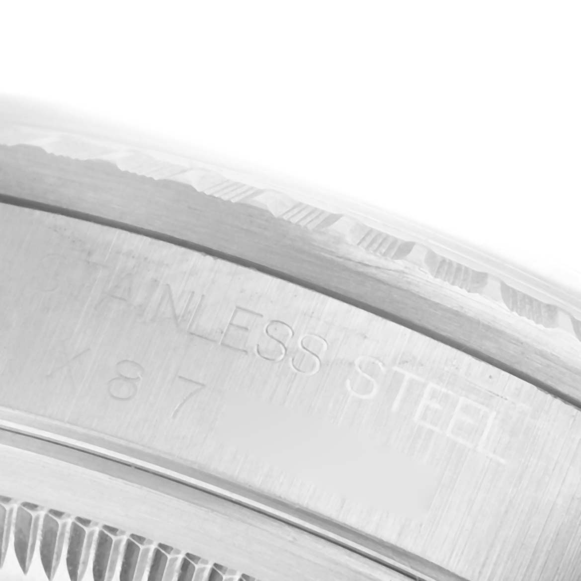 The image shows a close-up of the side engraving on a Rolex Datejust 16220 Men's Stainless Steel Silver Dial watch's stainless steel case.