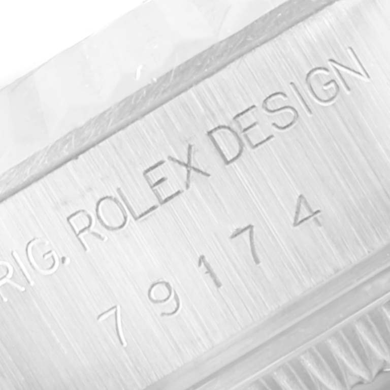 This image shows a close-up of the serial number and "ROLEX DESIGN" engraving on the case of a Rolex Datejust 79174 Women's Stainless Steel Silver Dial 79174 Women's Stainless Steel Silver Dial watch.
