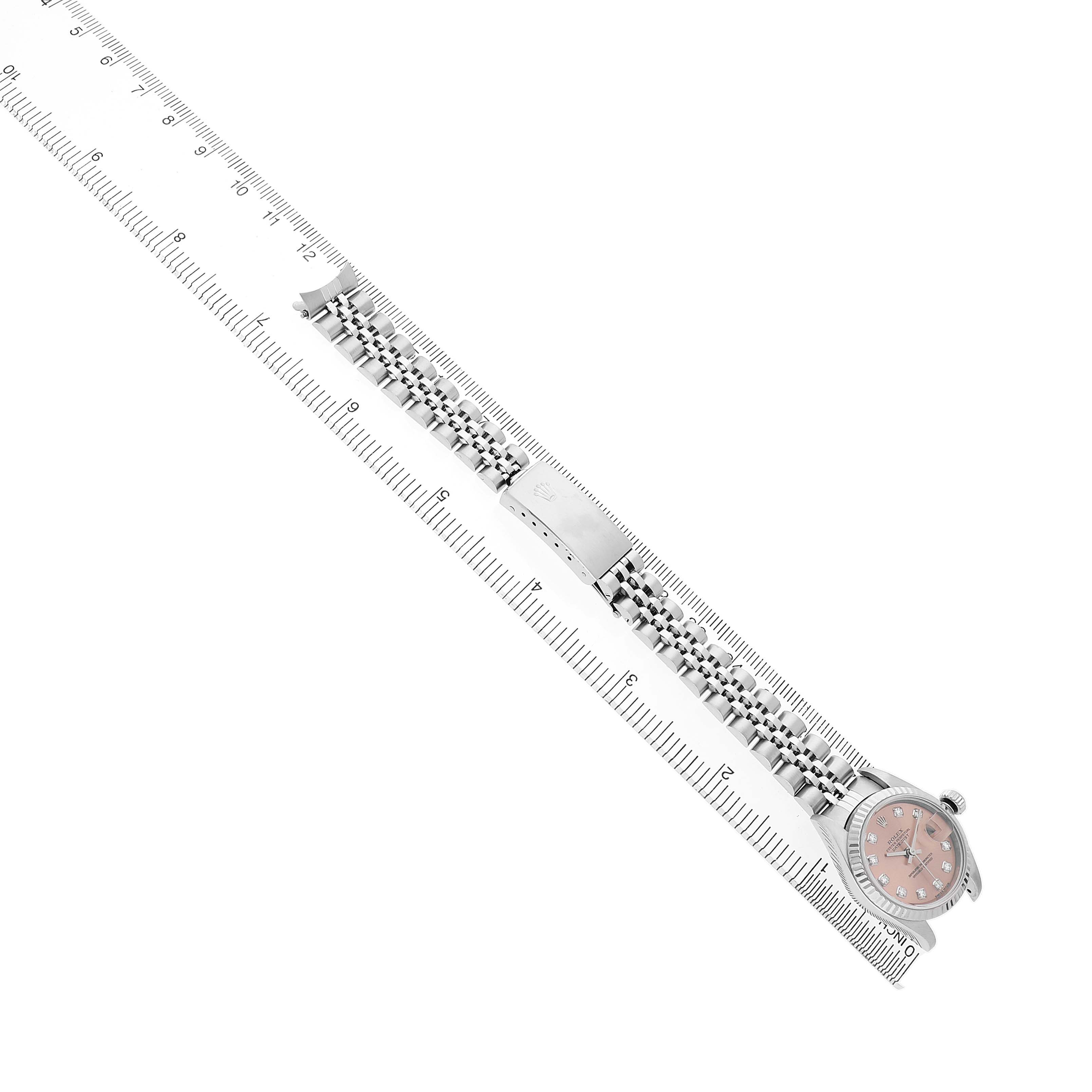 The Rolex Datejust 79174 Women's Stainless Steel Pink Dial watch is shown from an angled top view, highlighting the face, bezel, and bracelet clasp.