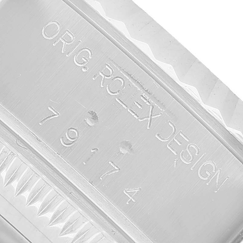 The image shows the engraved side of the case of a Rolex Datejust 79174 Women's Stainless Steel Pink Dial, highlighting the branding and design serial.