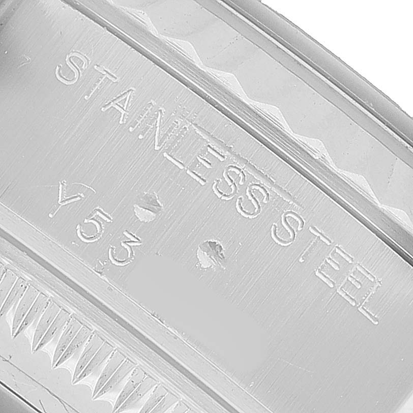 The image shows a close-up of the Rolex Datejust 79174 Women's Stainless Steel Pink Dial model's stainless steel case with engraved text.