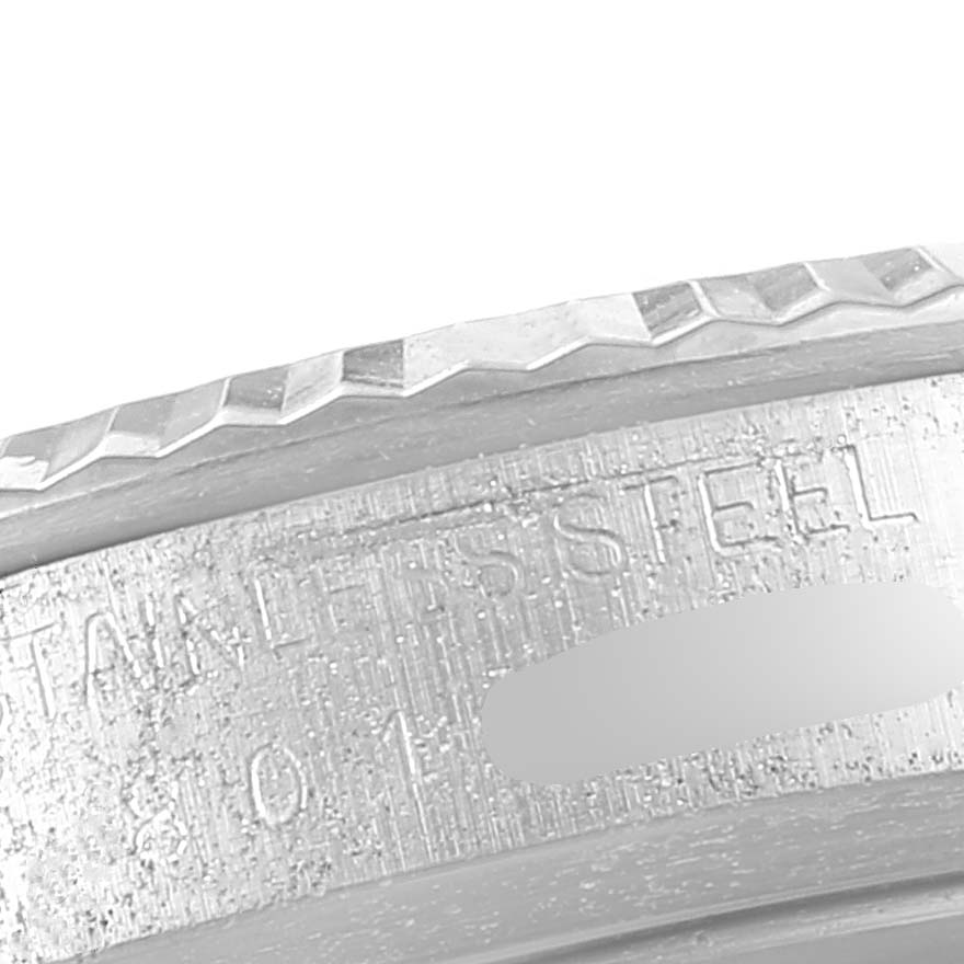 The image shows a close-up of the stainless steel case and bezel edge of a Vintage Collection Rolex watch.