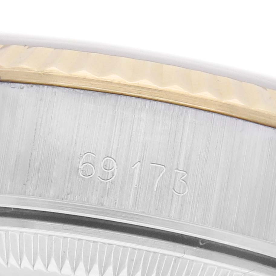 The image shows a close-up of the Rolex Datejust 69173 Women
s Steel and Gold (two tone) Champagne Dial 69173 Women
s Steel and Gold (two tone) Champagne Dial
s bezel and case side, highlighting the model number engraving.