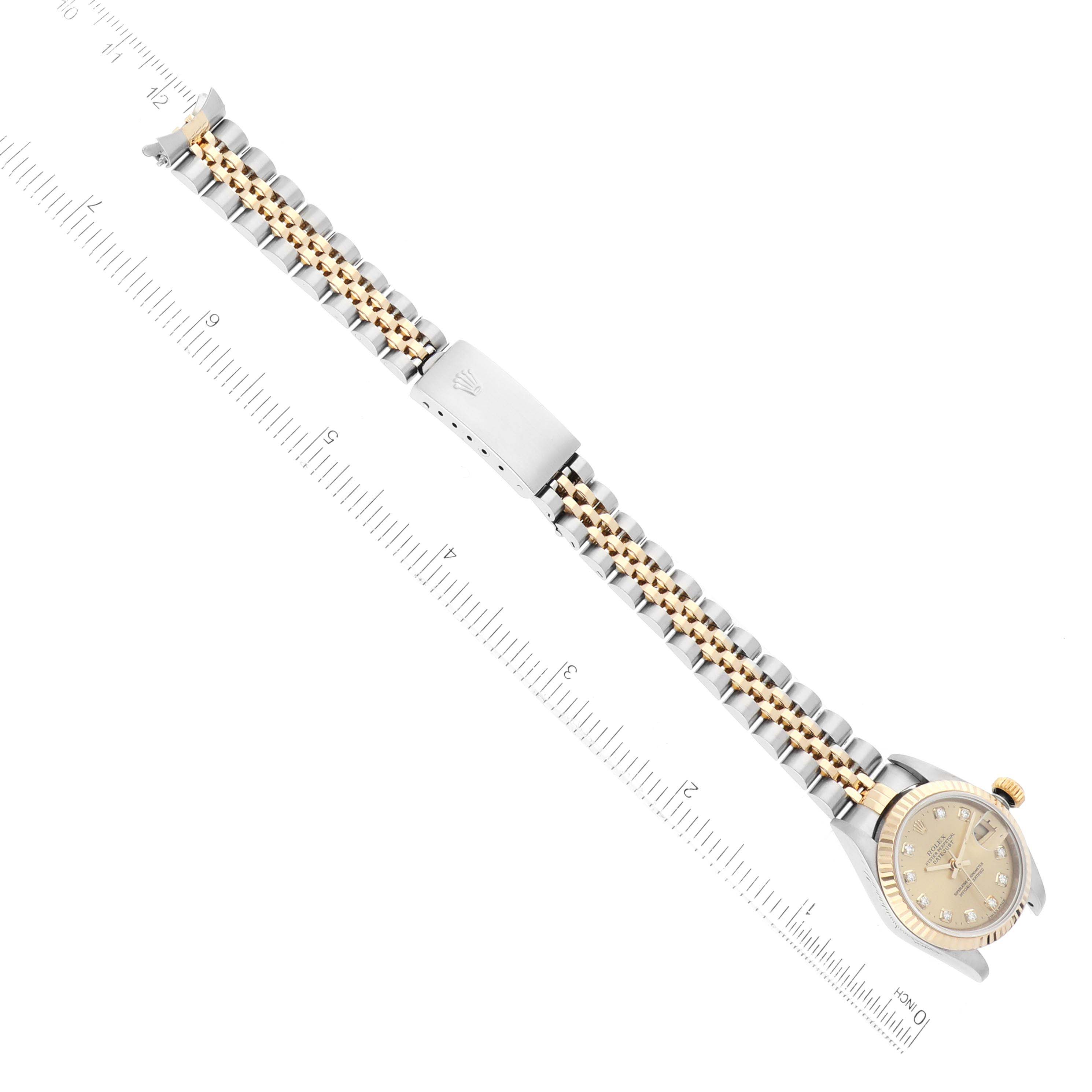 The image shows a Rolex Datejust 79173 Women's Steel and Gold (two tone) Champagne Dial 79173 Women's Steel and Gold (two tone) Champagne Dial watch, shot from above, featuring a two-tone metal bracelet and a clasp, along with the dial and case.