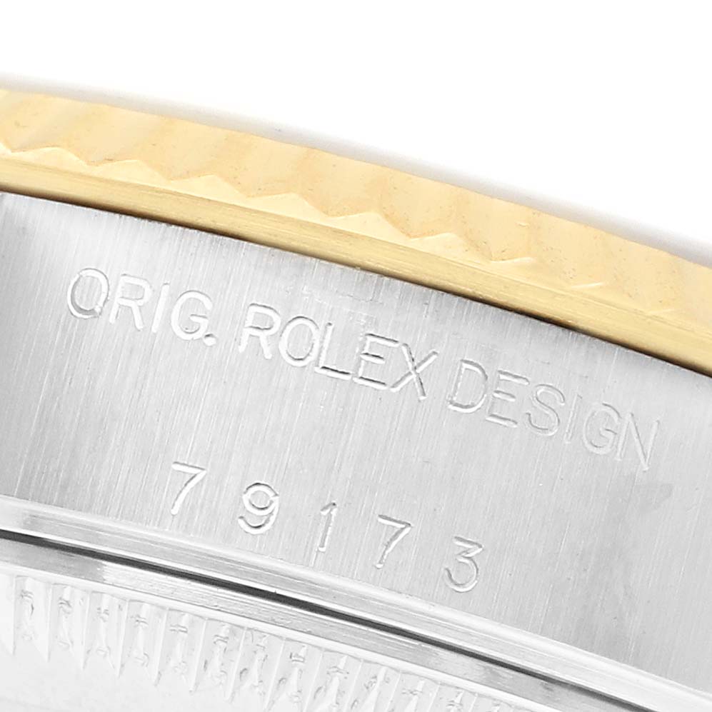 The image shows a close-up of the case engraved with "ORIG. ROLEX DESIGN" and the model number on the Rolex Datejust 79173 Women's Steel and Gold (two tone) Champagne Dial.