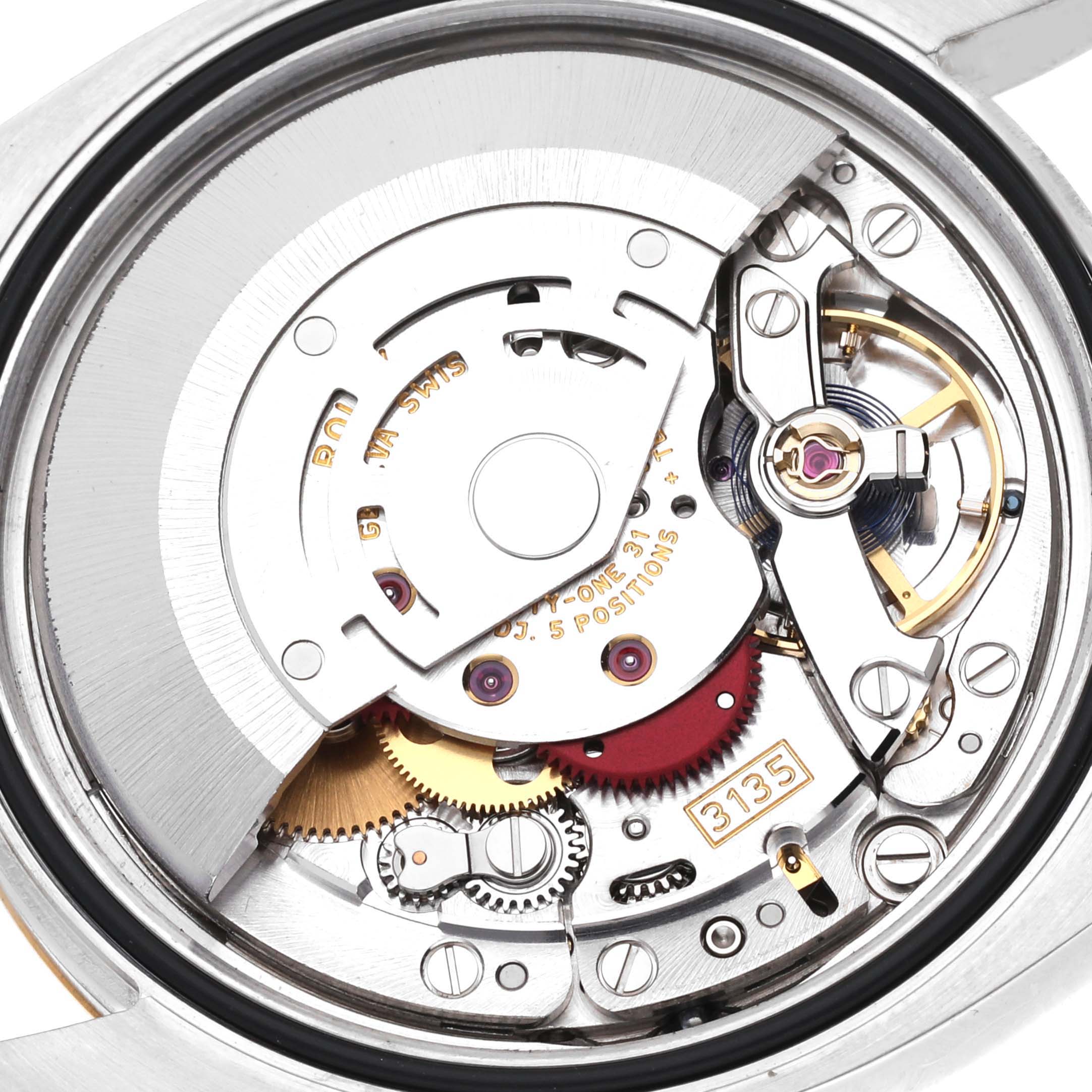 This image shows the internal mechanism of a Rolex Datejust 116233 Men's Steel and Gold (two tone) Champagne Dial 116233 Men's Steel and Gold (two tone) Champagne Dial model watch, focusing on its intricate gears and movement.