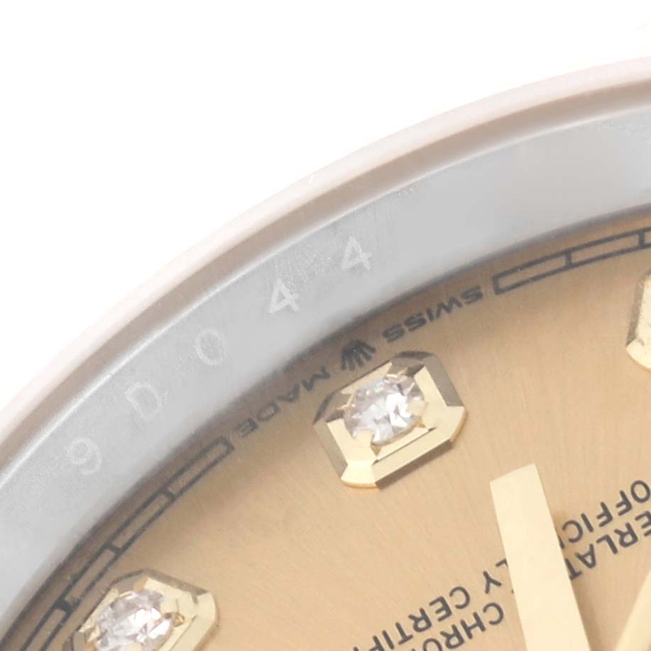 The image shows a close-up of the dial and part of the bezel of a Rolex Datejust 126233 Men's Steel and Gold (two tone) Champagne Dial 126233 Men's Steel and Gold (two tone) Champagne Dial watch, highlighting some diamond hour markers.