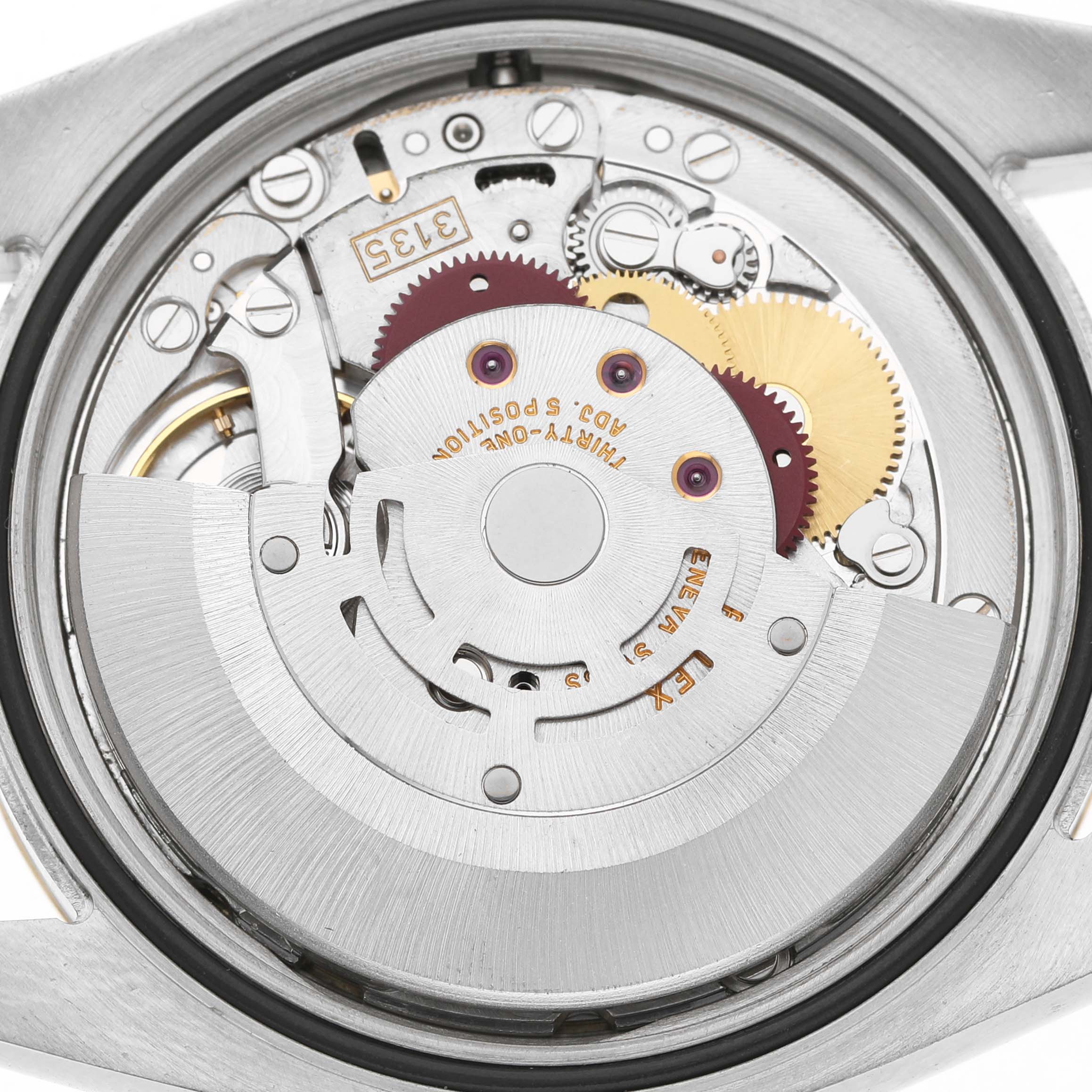 The image shows the movement mechanism of a Rolex Datejust 116233 Women's Steel and Gold (two tone) Champagne Dial watch from the back, highlighting gears and rotor.