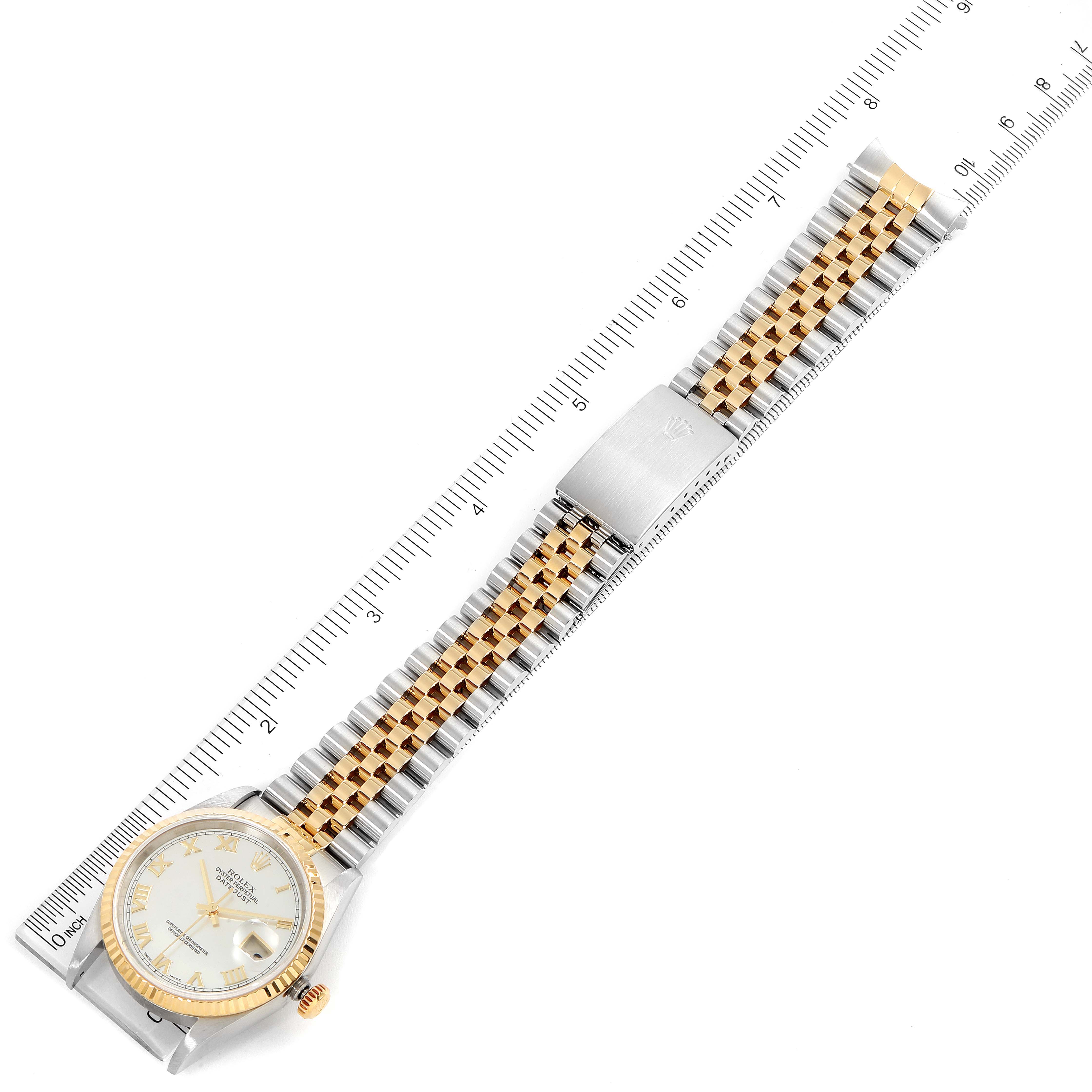 The image shows a top view of a Rolex Datejust 16233 Men's Steel and Gold (two tone) Mother of Pearl Dial 16233 Men's Steel and Gold (two tone) Mother of Pearl Dial watch, displaying its face, bezel, and two-tone bracelet, placed against a ruler.