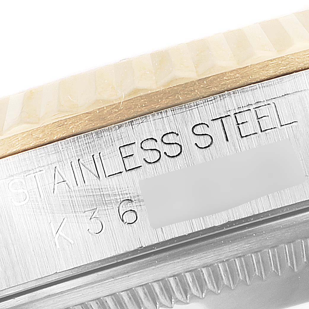 The image shows a close-up side view of the bezel and case of a Rolex Datejust 16233 Men's Steel and Gold (two tone) Mother of Pearl Dial 16233 Men's Steel and Gold (two tone) Mother of Pearl Dial watch, highlighting the "STAINLESS STEEL" engraving.