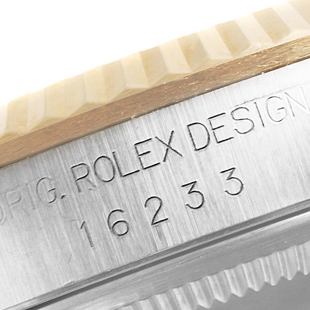 This close-up image shows the side engraving of the bezel and case of a Rolex Datejust 16233 Men's Steel and Gold (two tone) Mother of Pearl Dial 16233 Men's Steel and Gold (two tone) Mother of Pearl Dial watch with the model number 16233.