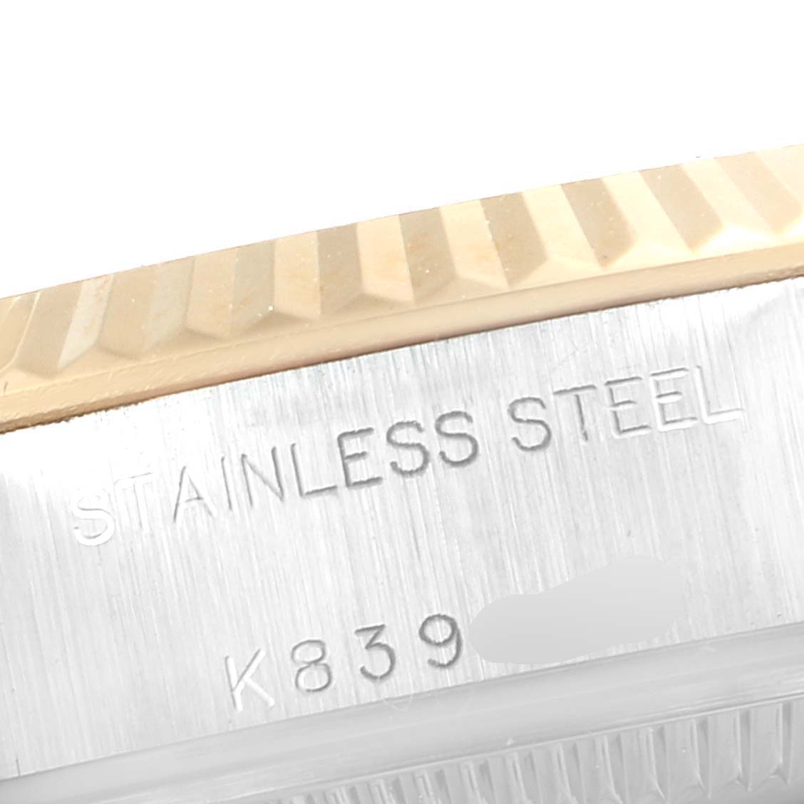 The image shows a close-up of the stainless steel part and the fluted bezel of a Rolex Datejust 79173 Women's Steel and Gold (two tone) Beige Dial 79173 Women's Steel and Gold (two tone) Beige Dial watch.