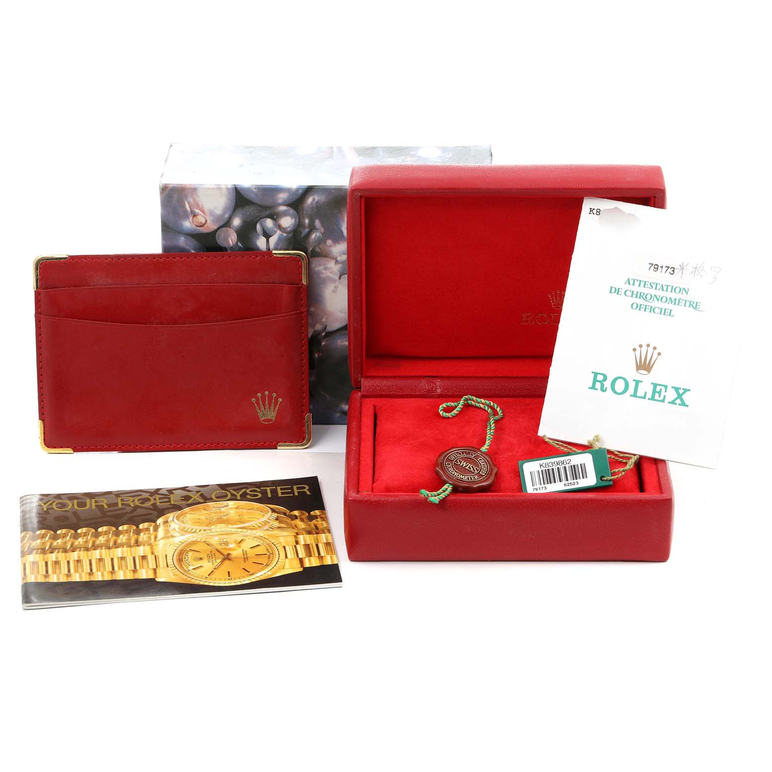 This image shows the packaging, documentation, and accessories for a Rolex Datejust 79173 Women's Steel and Gold (two tone) Beige Dial 79173 Women's Steel and Gold (two tone) Beige Dial watch, including its red box, booklet, and tags.