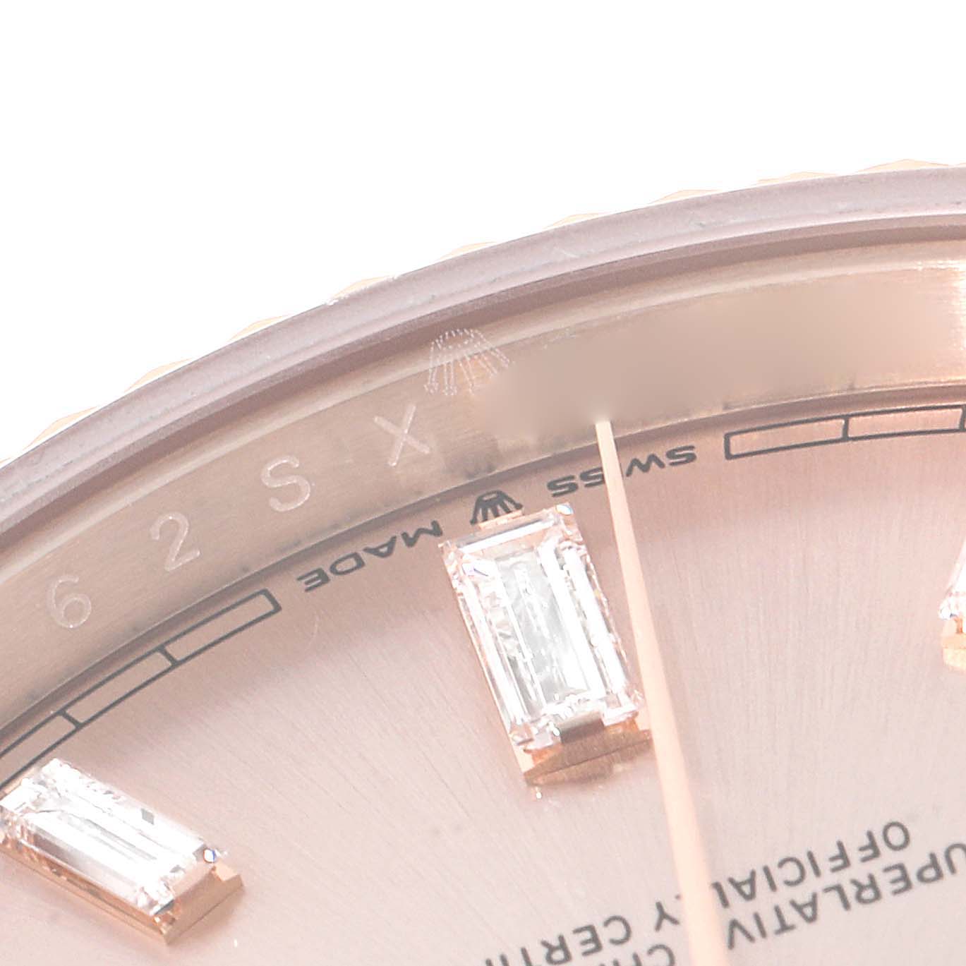 This close-up angle shows the dial, diamond markers, and partial engraving of a Rolex President 228235 Men's Rose Gold Pink Dial 228235 Men's Rose Gold Pink Dial watch.