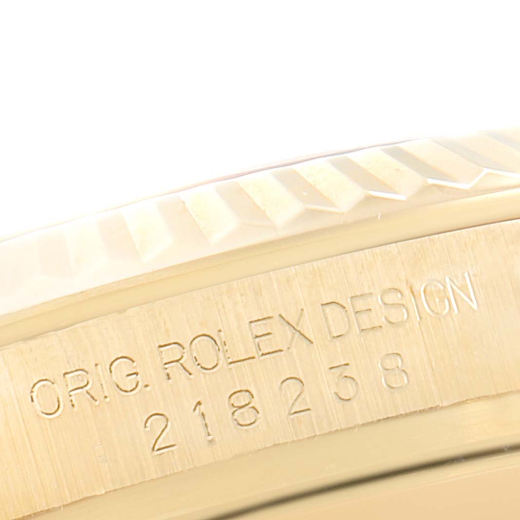 This close-up image shows the engraved case and fluted bezel of a Rolex President 218238 Men's Yellow Gold Silver Dial 218238 Men's Yellow Gold Silver Dial model watch.