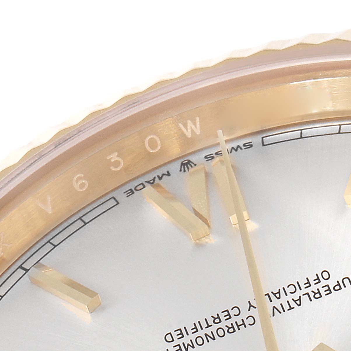 The close-up image of the Rolex President 218238 Men's Yellow Gold Silver Dial 218238 Men's Yellow Gold Silver Dial model watch shows part of the dial, hands, and gold fluted bezel.
