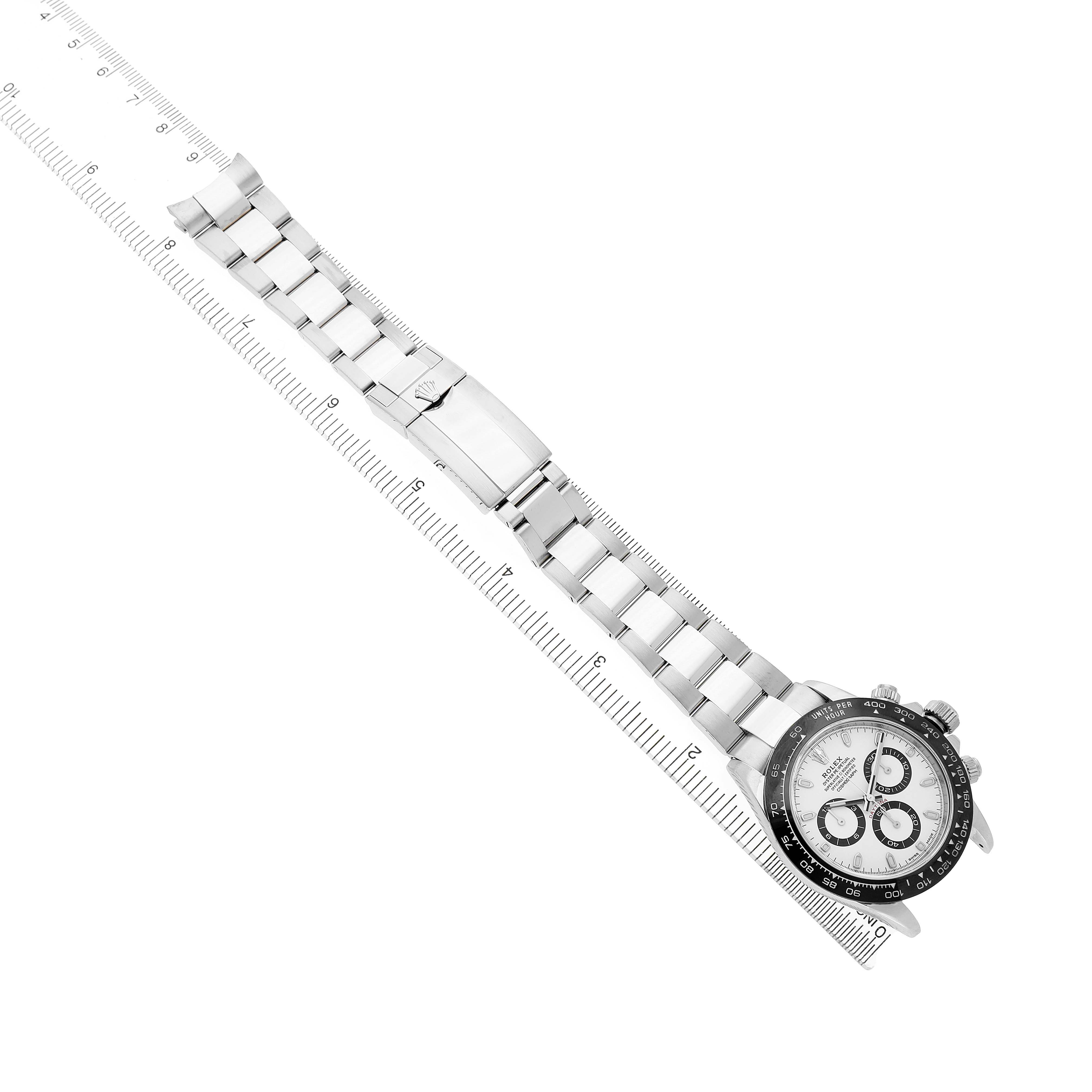 The Rolex Daytona 116500LN Men's Stainless Steel Yellow Dial watch is shown laying flat, showcasing its full bracelet, clasp, and watch face at an angle.