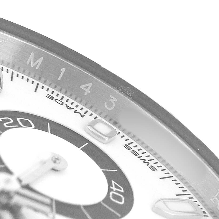 The image shows a close-up of the Rolex Daytona 116500LN Men's Stainless Steel Yellow Dial's bezel and part of the dial from an oblique angle.