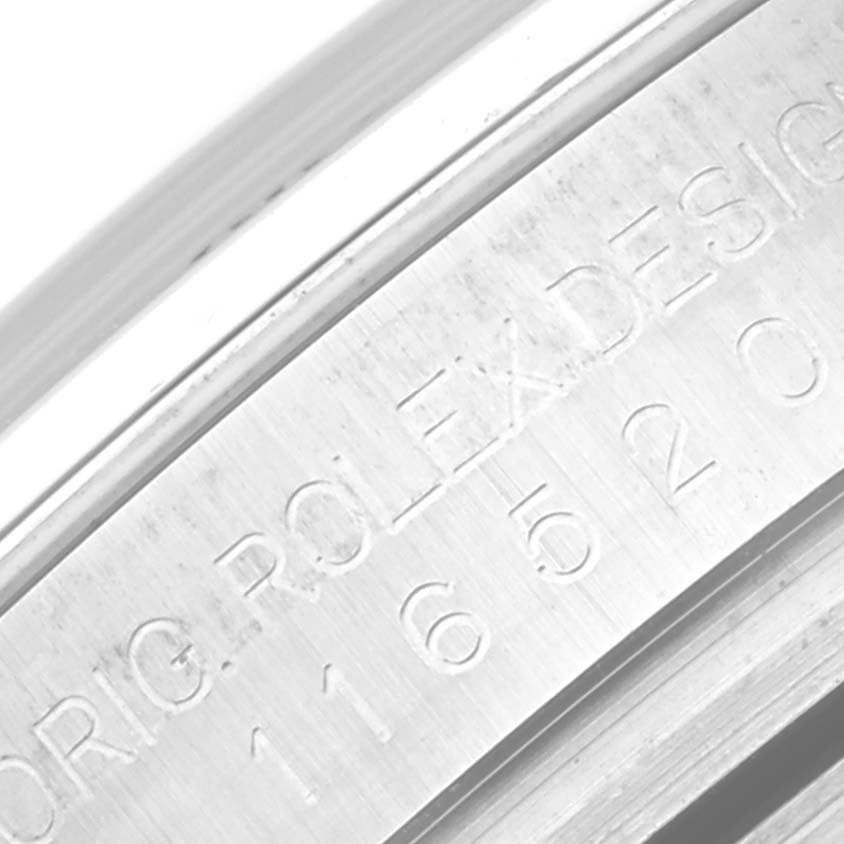 This close-up image shows the engraved model number and "ROLEX DESIGN" inscription on the inner bezel of the Rolex Daytona 116520 Men's Stainless Steel White Dial 116520 Men's Stainless Steel White Dial watch.