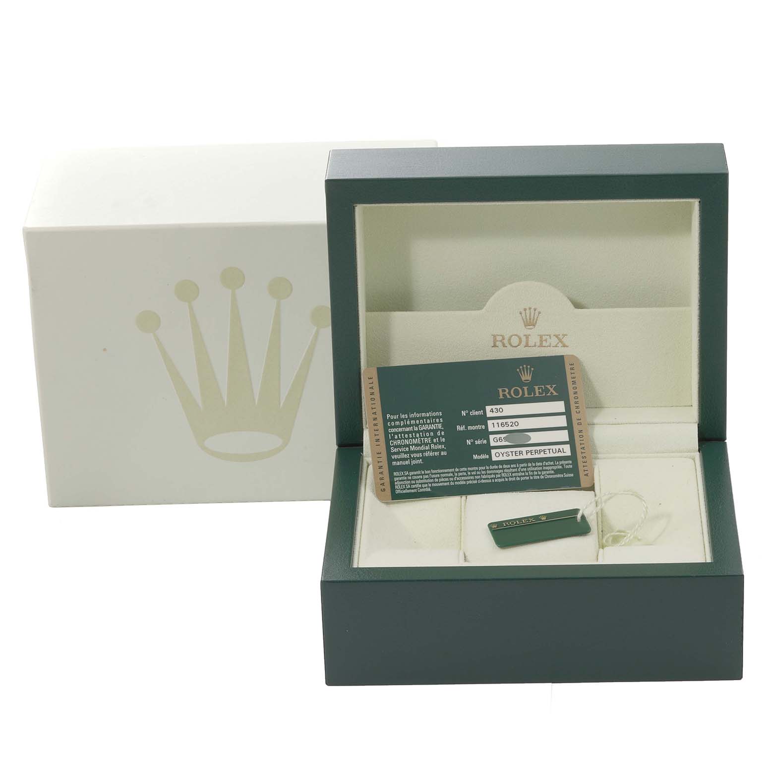 The image shows the packaging and accessories of a Rolex Daytona 116520 Men's Stainless Steel White Dial 116520 Men's Stainless Steel White Dial watch, including the box, warranty card, and tag.