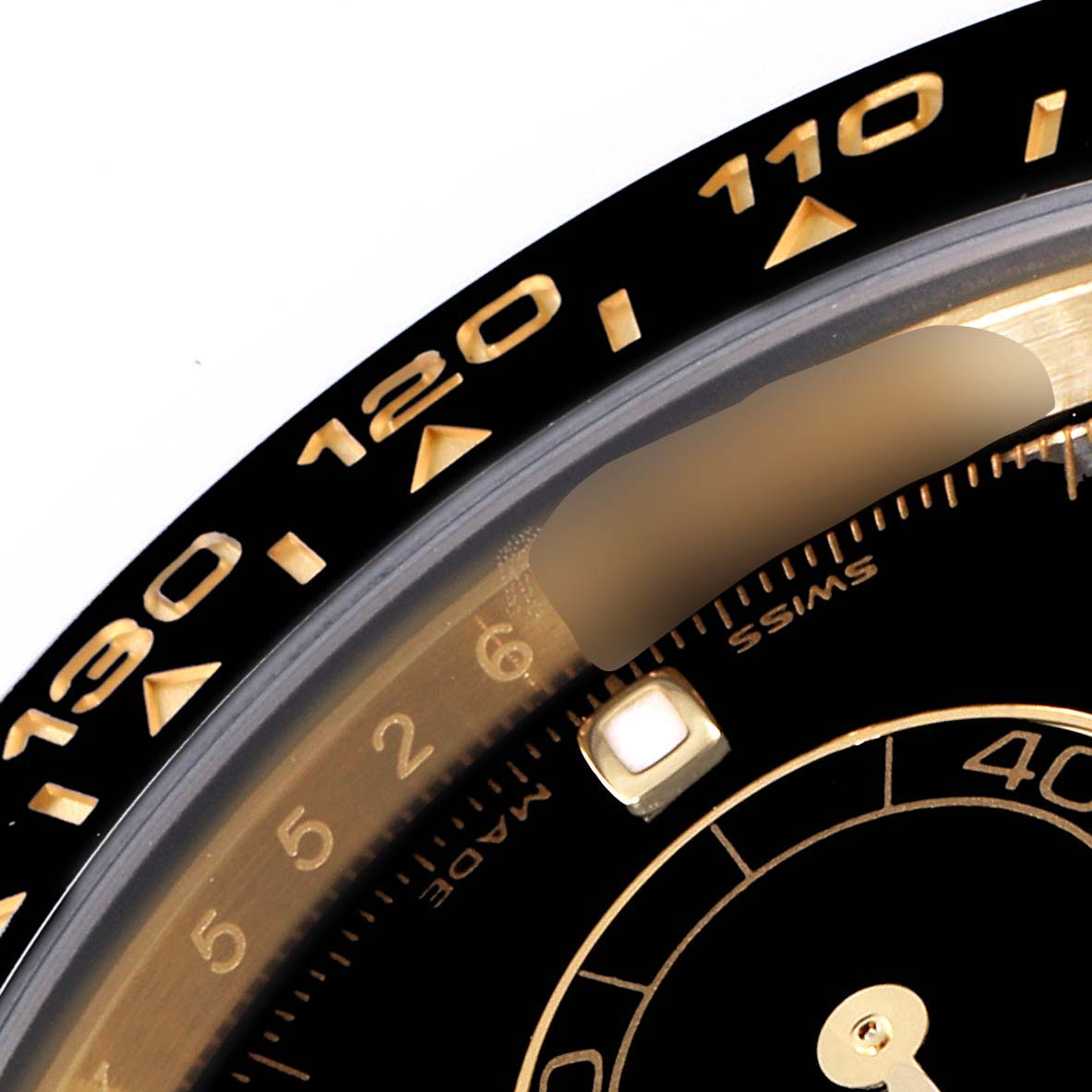 This image shows a close-up angle of the bezel and a portion of the dial of a Rolex Daytona 116518 Men's Yellow Gold Black Dial 116518 Men's Yellow Gold Black Dial watch.