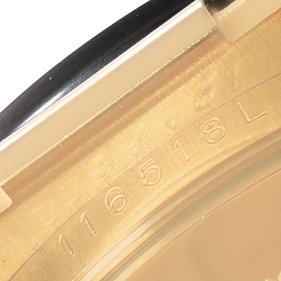 This image shows a close-up of the case back and part of the serial number of a Rolex Daytona 116518 Men's Yellow Gold Black Dial 116518 Men's Yellow Gold Black Dial watch.
