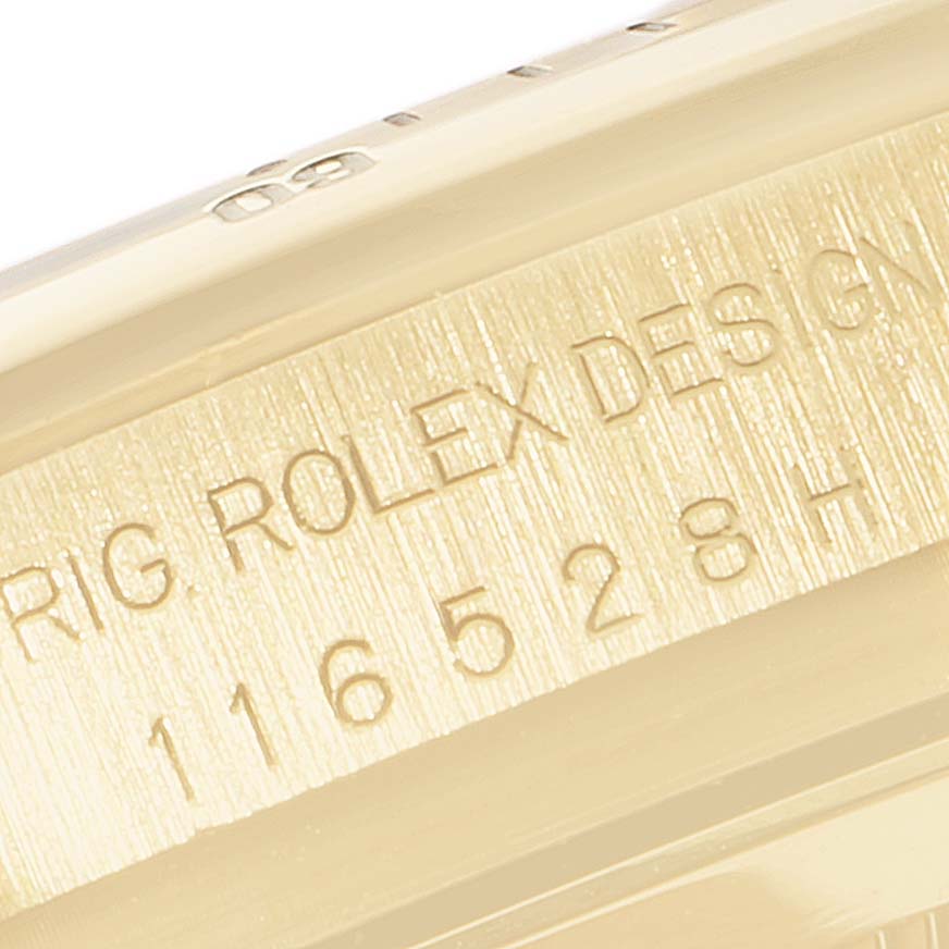 This image shows a close-up of the engraved serial number on the casing of a Rolex Daytona 116528 Men's Yellow Gold Mother of Pearl Dial 116528 Men's Yellow Gold Mother of Pearl Dial watch.