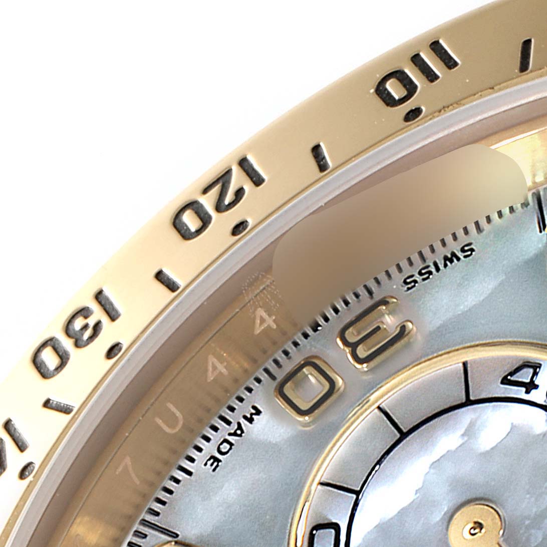 The image shows a close-up of the Rolex Daytona 116528 Men's Yellow Gold Mother of Pearl Dial 116528 Men's Yellow Gold Mother of Pearl Dial watch's bezel and part of the dial with numbers and "SWISS MADE" text.
