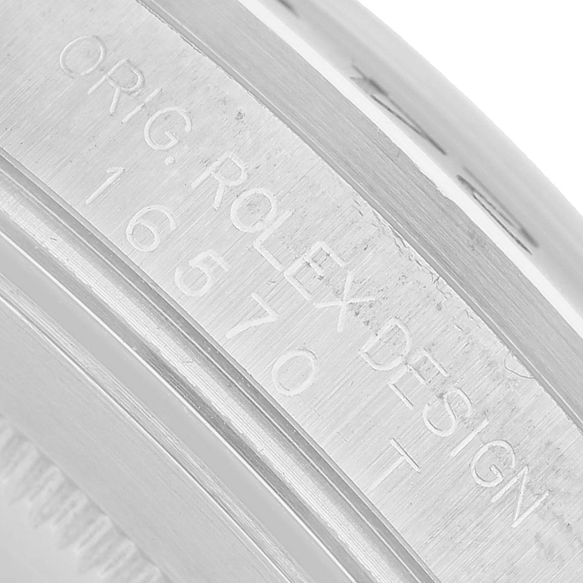 The image shows a close-up of the engraved serial number and design details on the side of the Rolex Explorer 16570 Men's Stainless Steel Black Dial watch case.