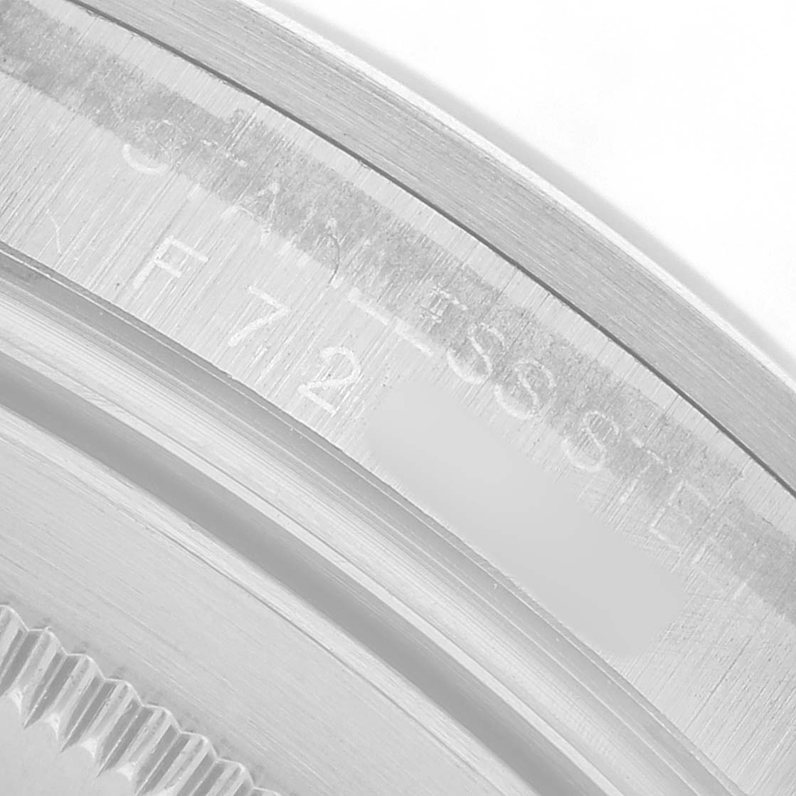 The image shows a close-up of the stainless steel case back and edge engraving of a Rolex Explorer 16570 Men's Stainless Steel White Dial watch.