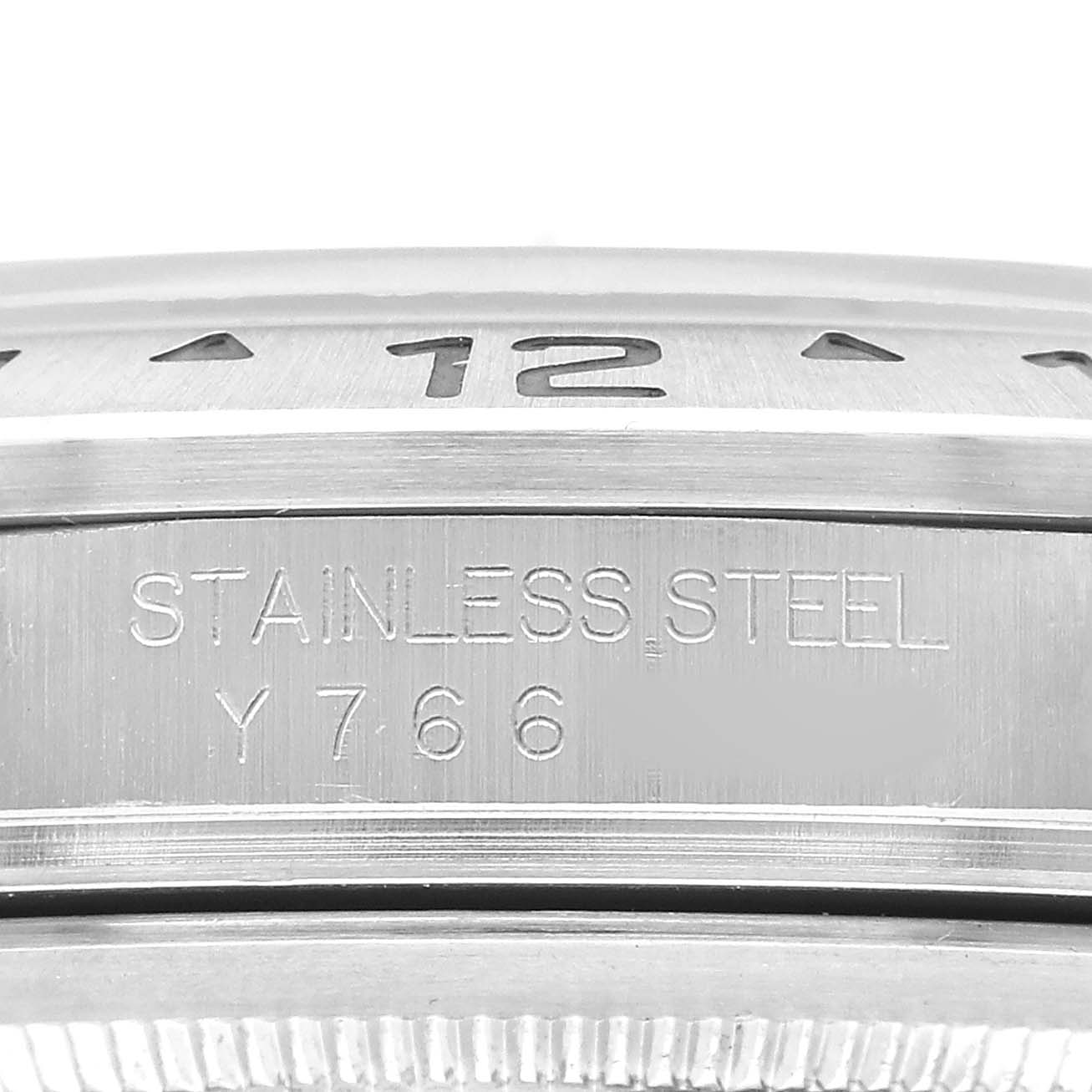 The image shows a close-up of the stainless steel band and bezel of a Rolex Explorer 16570 Men's Stainless Steel White Dial watch, highlighting the engraving.