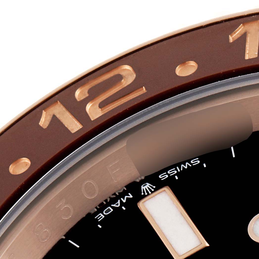 This is a close-up of the bezel and dial of a Rolex GMT-Master 126715 Men's Rose Gold Black Dial 126715 Men's Rose Gold Black Dial watch, showing the 12-hour marker and Swiss Made notation.