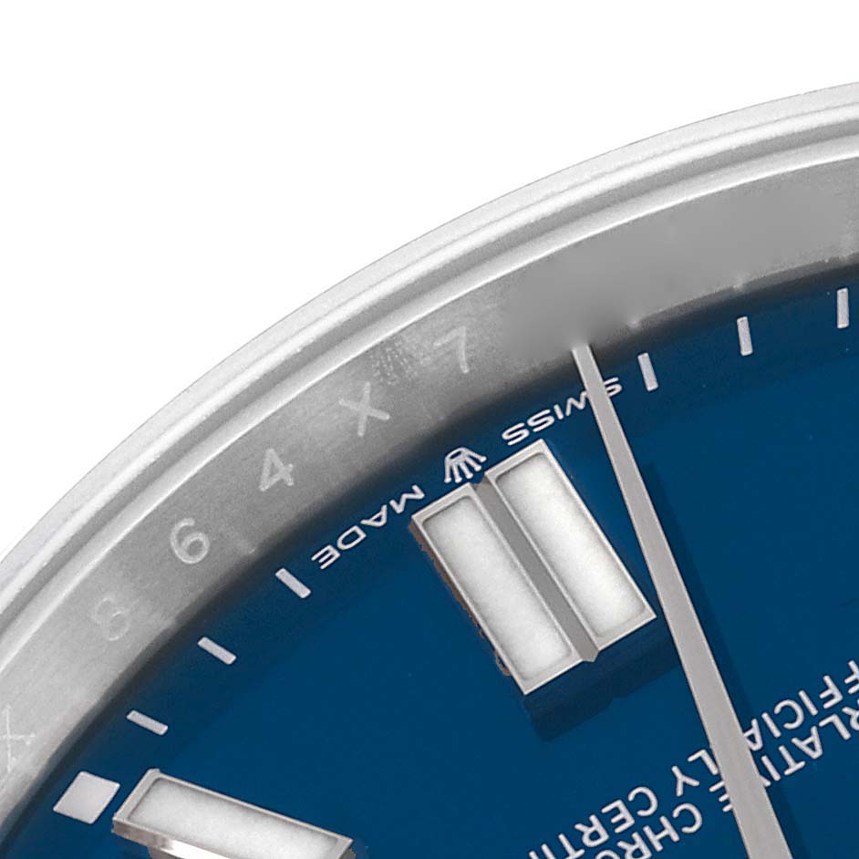 This image shows a close-up of the dial and bezel of a Rolex Oyster Perpetual 124300 Men's Stainless Steel Blue Dial 124300 Men's Stainless Steel Blue Dial watch, focusing on the hour markers and the "Swiss Made" label.