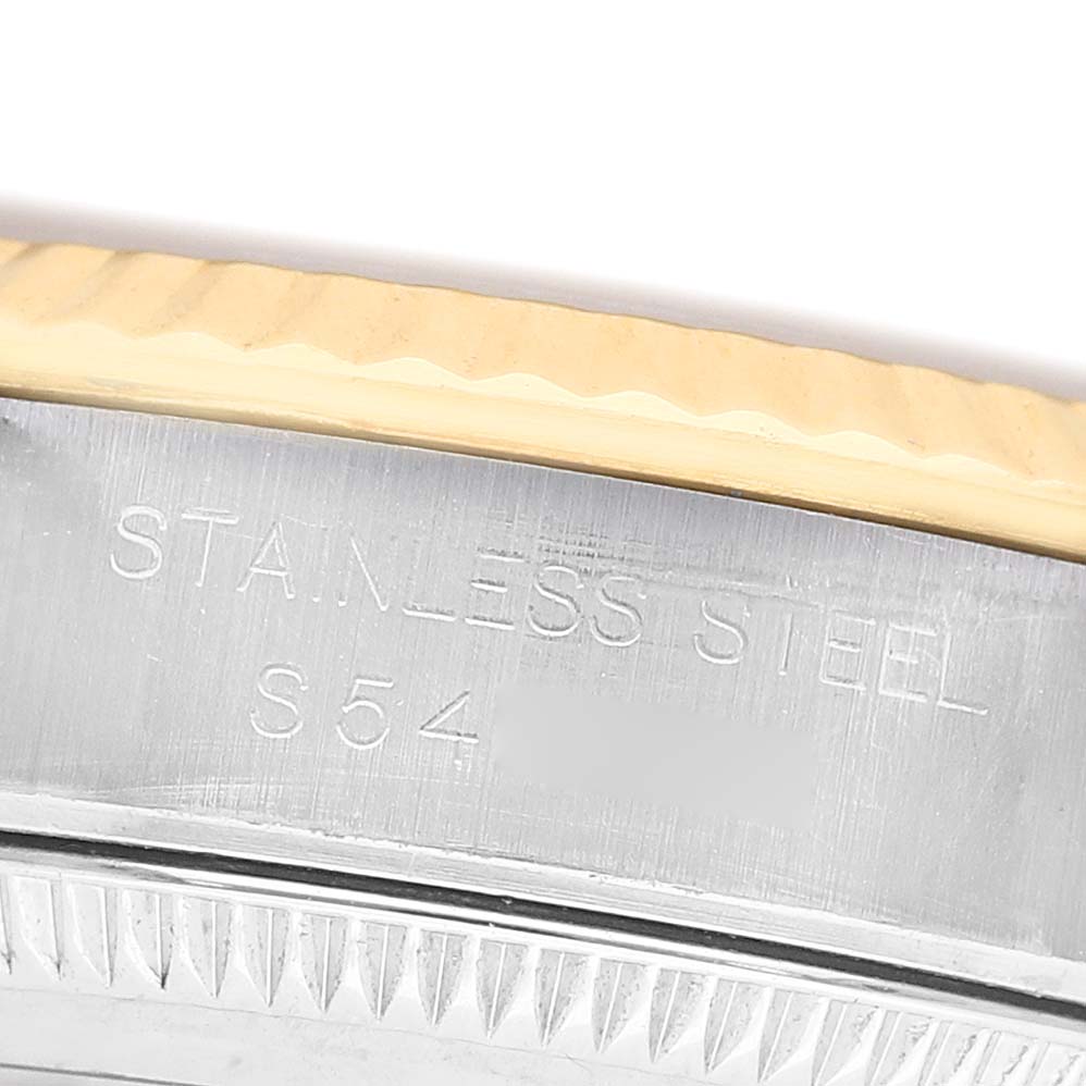 The image shows a close-up of the side of a Rolex Datejust 67193 Men's Steel and Gold (two tone) Champagne Dial watch, highlighting the "Stainless Steel" engraving near the bezel.