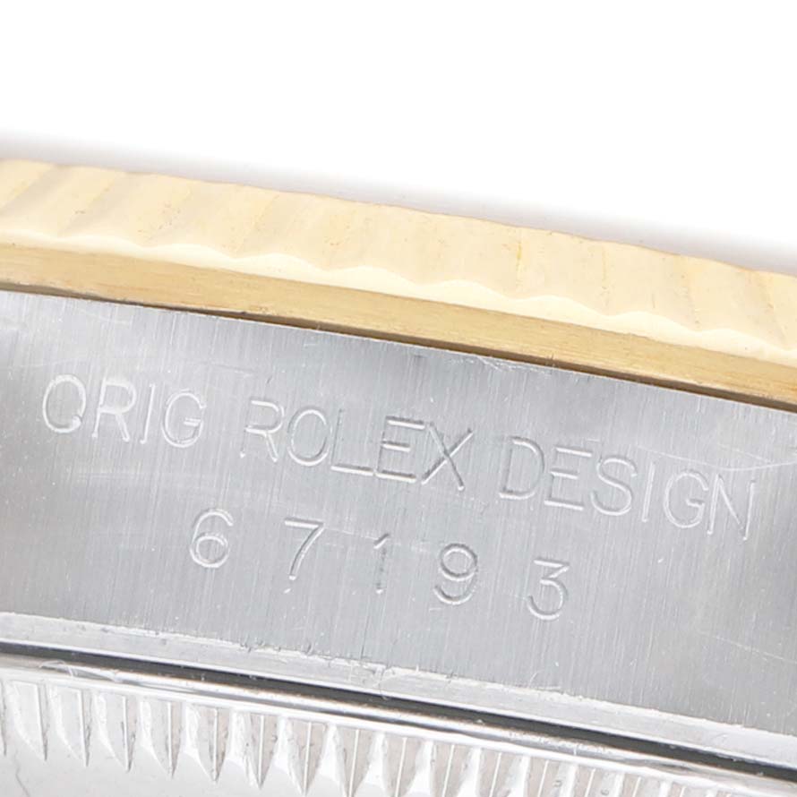 The image shows a close-up of the case side of a Rolex Datejust 67193 Men's Steel and Gold (two tone) Champagne Dial, highlighting its engraved model number.