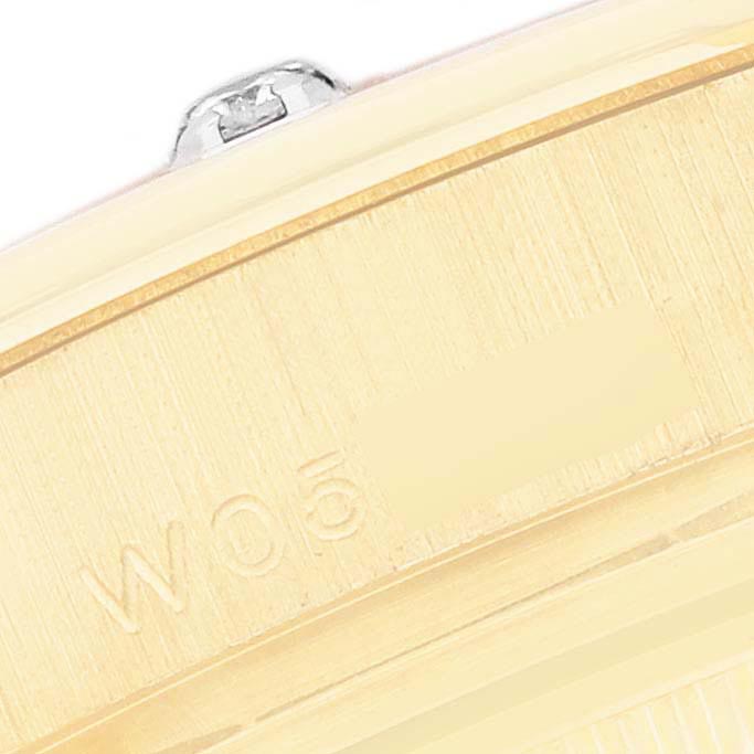 The image shows the side of a Rolex Pearlmaster 69318 Women
s Yellow Gold White Dial 69318 Women
s Yellow Gold White Dial watch, focusing on the serial number engraving and part of the crown.