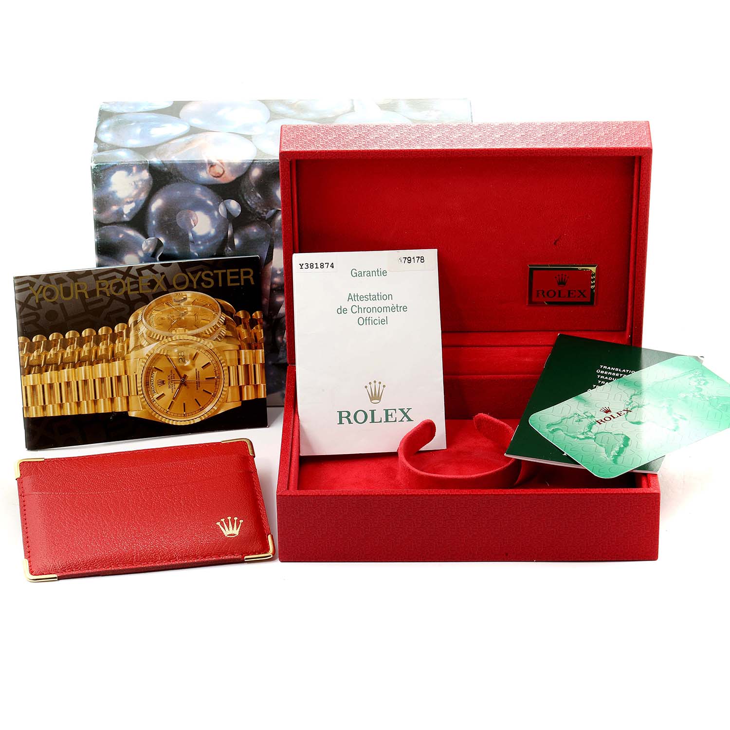 This image shows the packaging and accessories for a Rolex President 179178 Women
s Yellow Gold Champagne Dial 179178 Women
s Yellow Gold Champagne Dial model, including the box, manuals, and warranty cards.