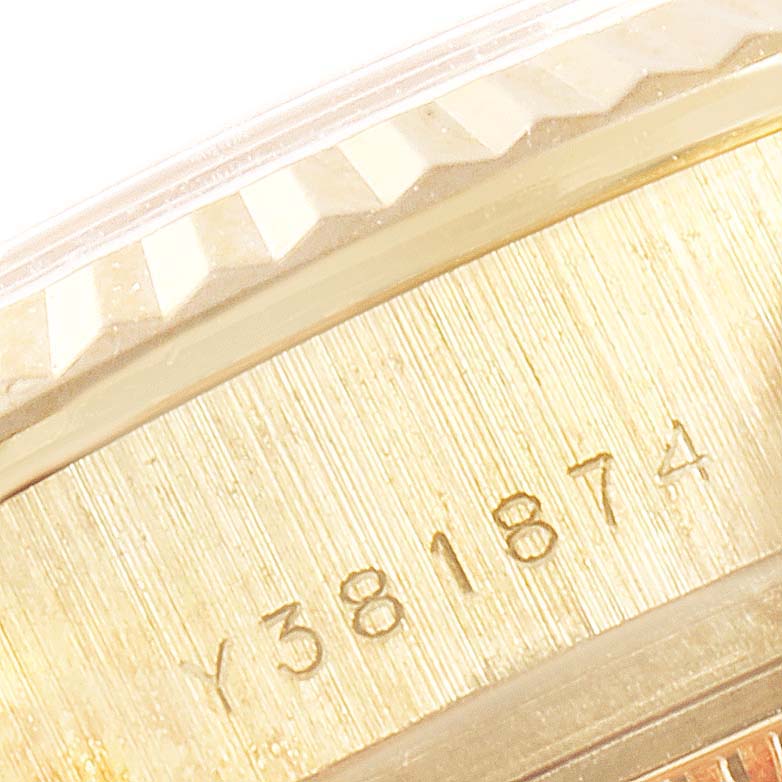 This image shows a close-up of the side of a Rolex President 179178 Women
s Yellow Gold Champagne Dial 179178 Women
s Yellow Gold Champagne Dial watch, highlighting the serial number and part of the fluted bezel.