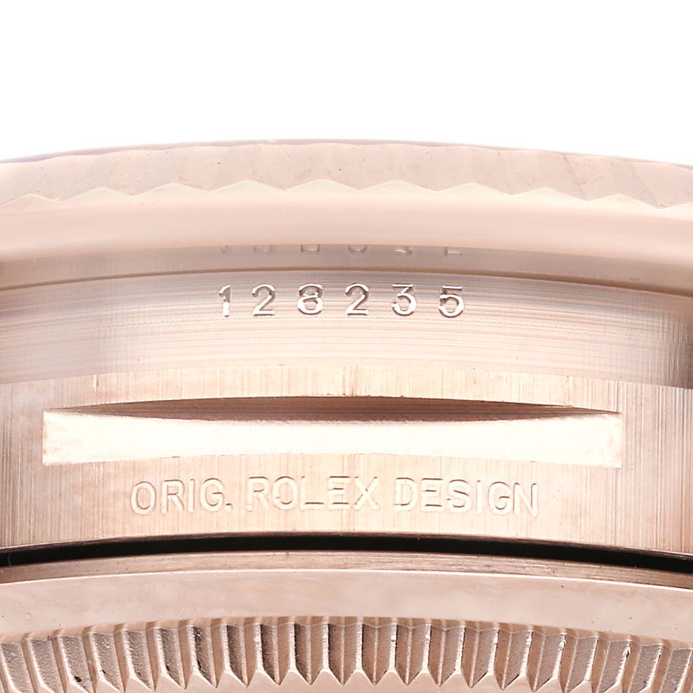 The image shows a close-up of the case side of a Rolex President 128235 Men's Rose Gold White Dial 128235 Men's Rose Gold White Dial watch, highlighting its model number and "ORIG. ROLEX DESIGN" engraving.