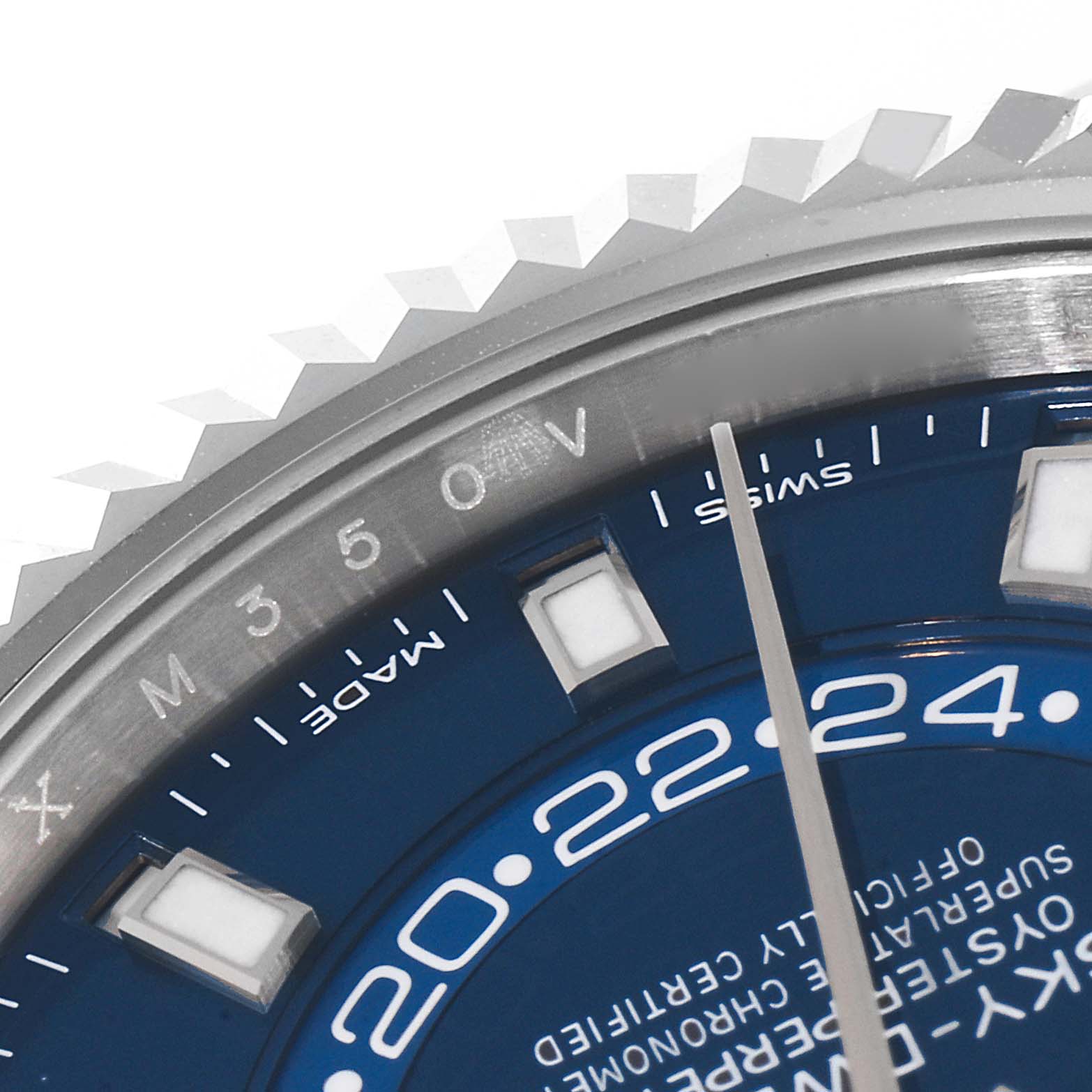 Close-up of the Rolex Sky-Dweller 326934 Men's Stainless Steel Blue Dial 326934 Men's Stainless Steel Blue Dial watch showing a portion of the bezel, part of the dial, and the hour markers.