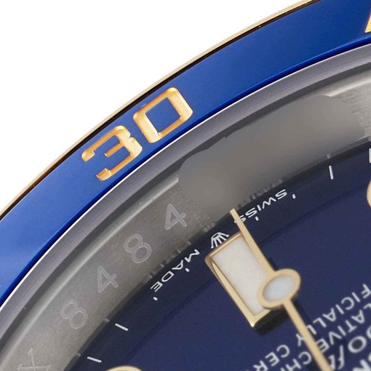 This close-up image of a Rolex Submariner 126613 Men's Steel and Gold (two tone) Blue Dial 126613 Men's Steel and Gold (two tone) Blue Dial shows part of the blue bezel, gold "30" marker, and the dial.
