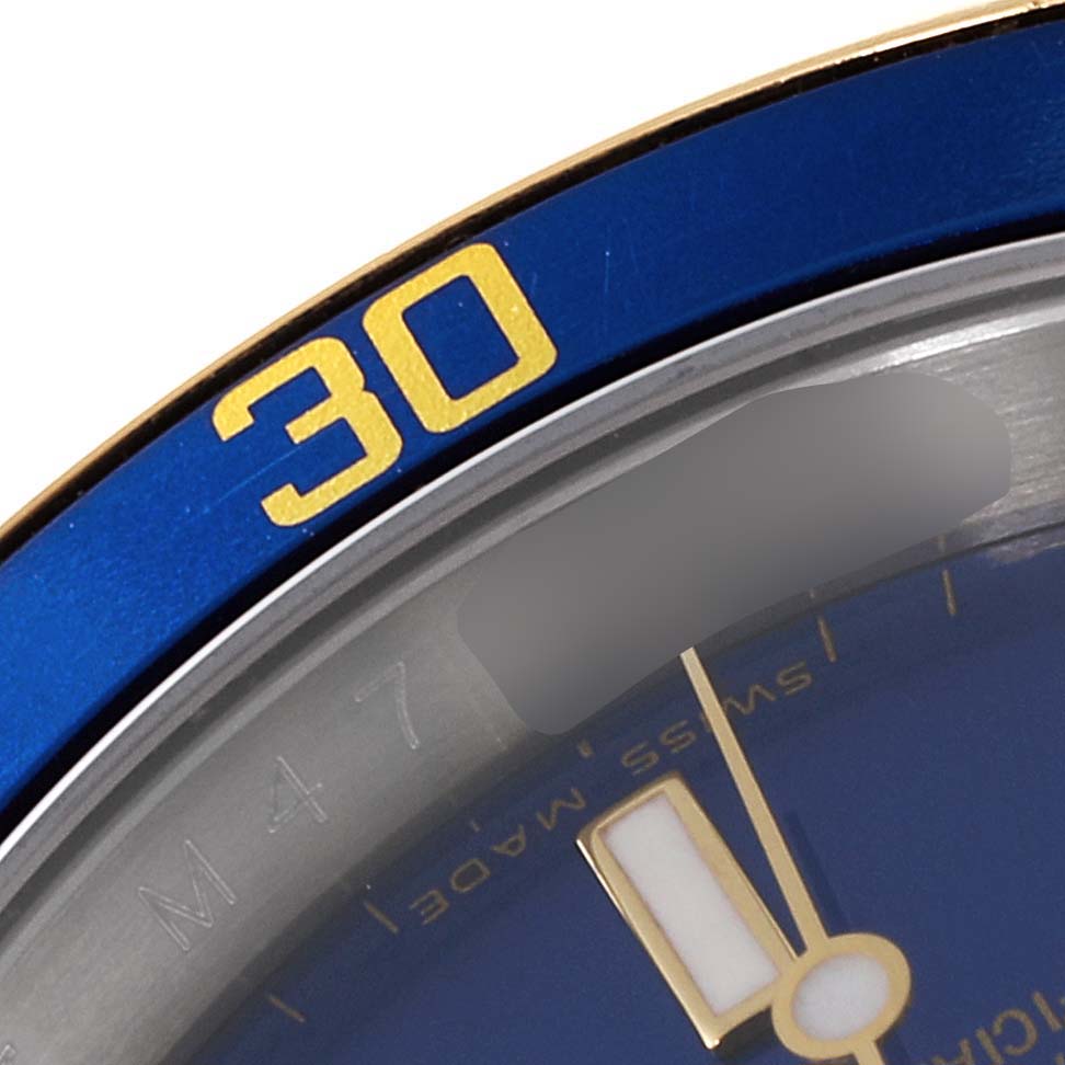 The image shows a close-up of the bezel and part of the dial of a Rolex Submariner 16613 Men
s Steel and Gold (two tone) Blue Dial 16613 Men
s Steel and Gold (two tone) Blue Dial watch, highlighting the "30" marker and watch hands.
