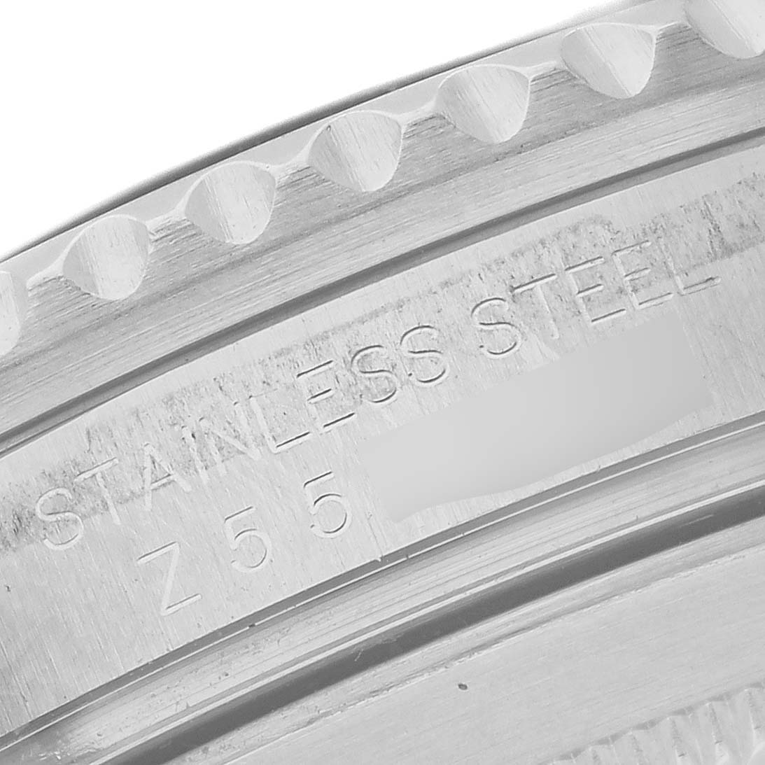 The image shows a close-up of the Rolex Submariner 16610LN Men's Stainless Steel Black Dial's engraving on the stainless steel case.