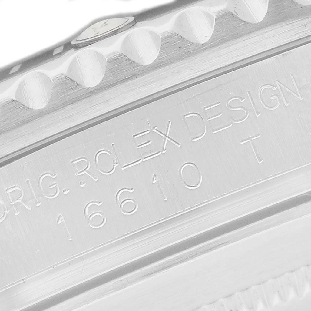 The image shows the engraved side detail of a Rolex Submariner 16610LN Men's Stainless Steel Black Dial watch, highlighting model and design numbers.