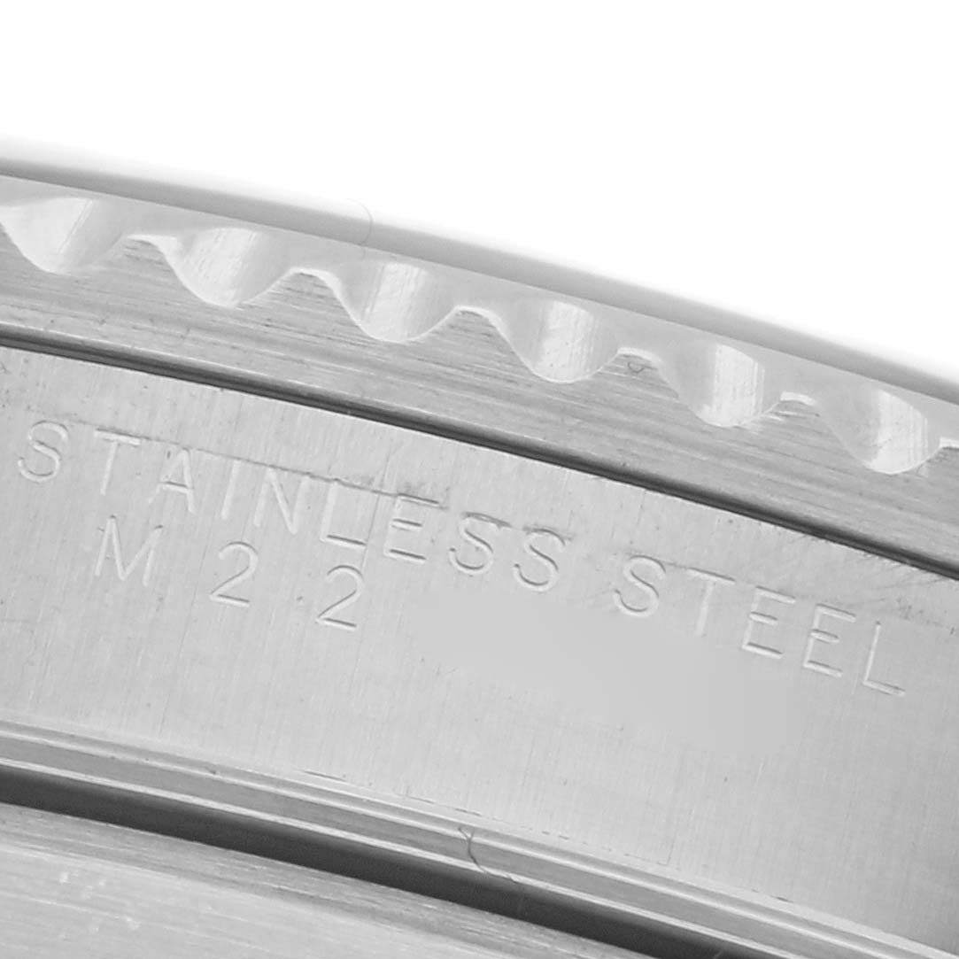 The image shows a close-up of the Rolex Submariner 14060 Men's Stainless Steel Black Dial 14060 Men's Stainless Steel Black Dial's stainless steel case edge, highlighting the engraved text.