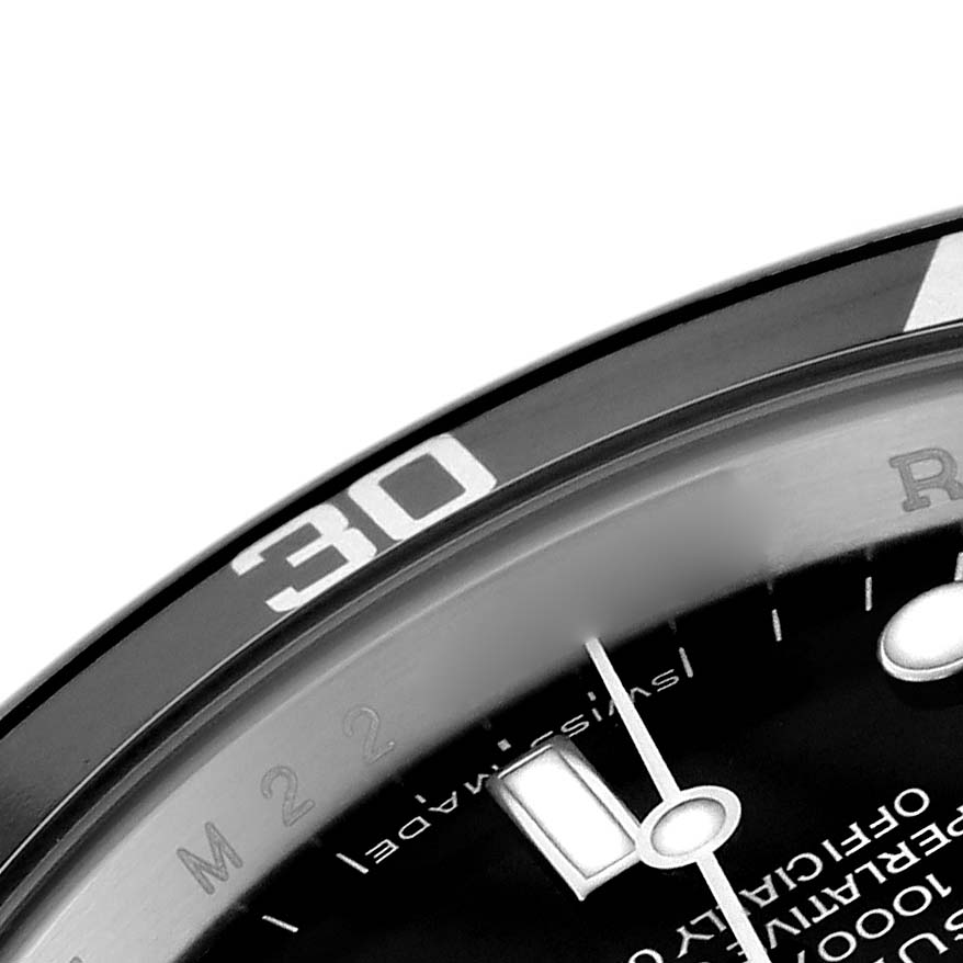 The image shows a close-up of the bezel and part of the dial on a Rolex Submariner 14060 Men's Stainless Steel Black Dial 14060 Men's Stainless Steel Black Dial, highlighting the minute markers.