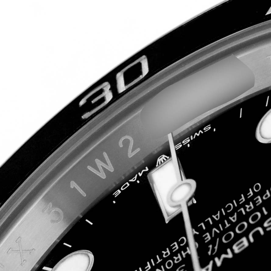 The image shows a close-up of the Rolex Submariner 124060 Men's Stainless Steel Black Dial's bezel and part of the dial, including the hour markers and hands.