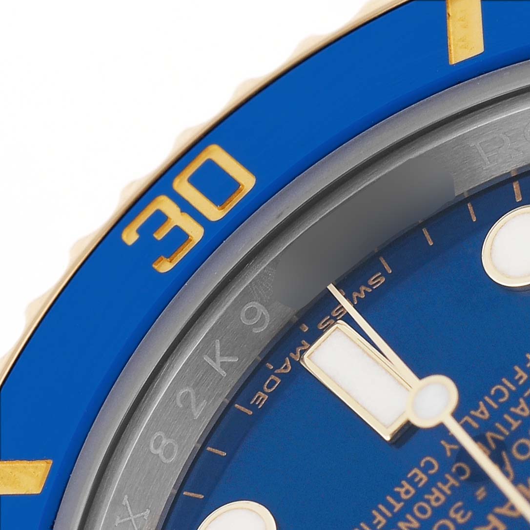 The image shows a partial view of a Rolex Submariner 116613 Men's Steel and Gold (two tone) Blue Dial model, focusing on the blue bezel and part of the dial.
