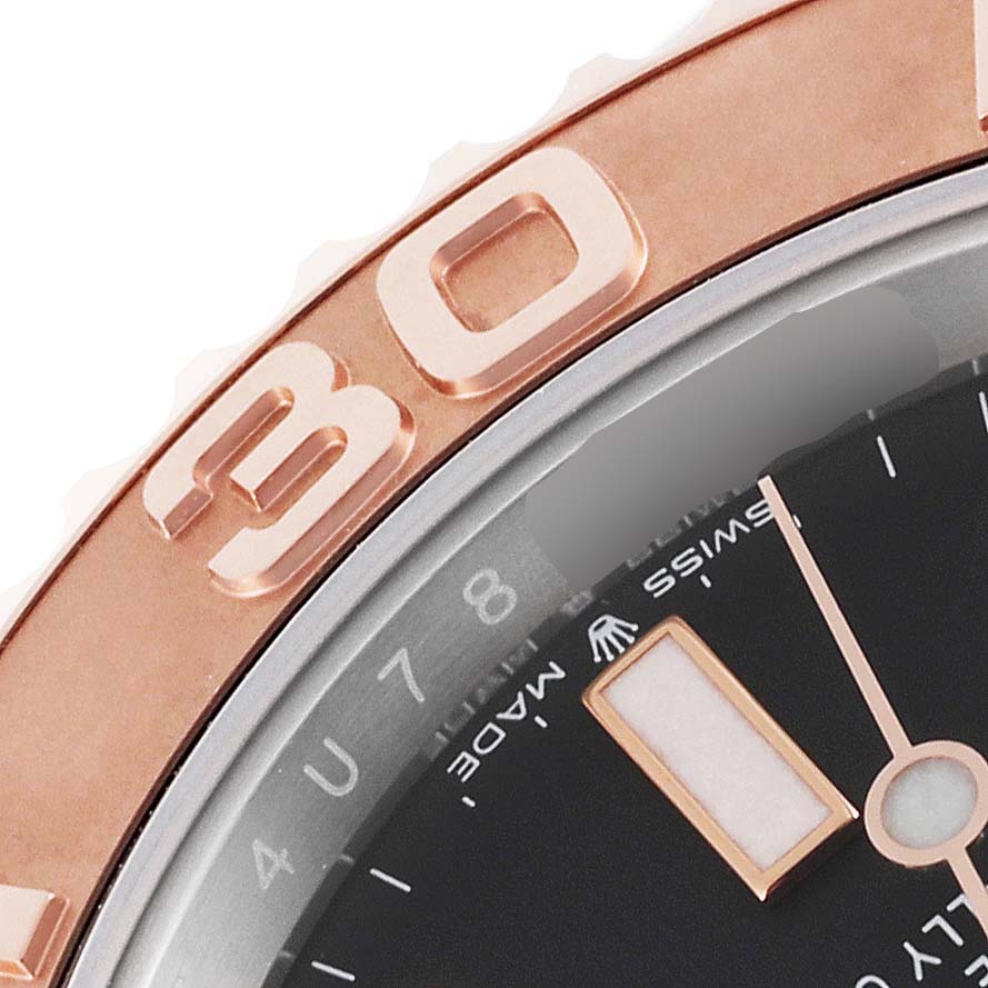 The image shows a close-up of the bezel and part of the dial of a Rolex Yacht-Master 126621 Men's Steel and Gold (two tone) Black Dial 126621 Men's Steel and Gold (two tone) Black Dial watch.